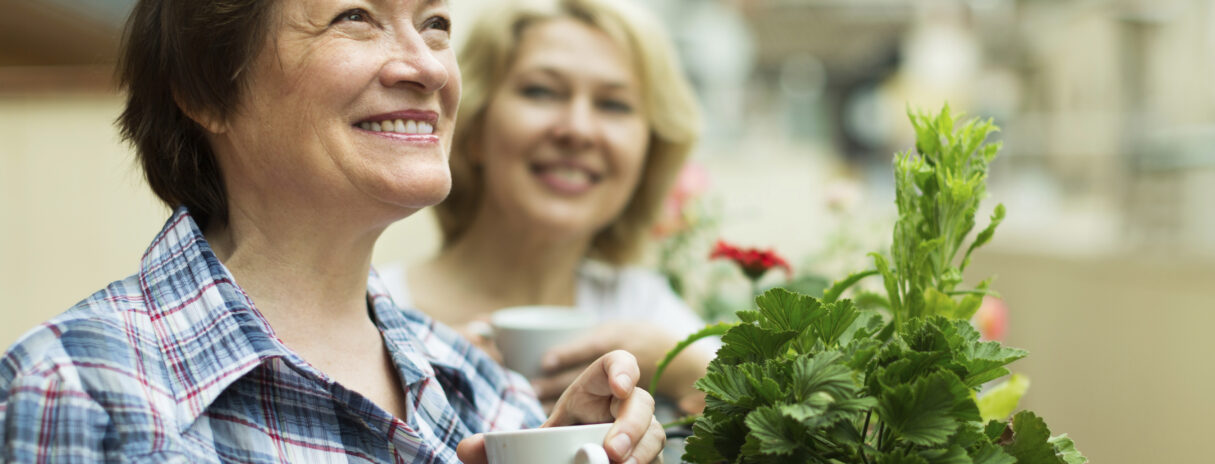 Woman in garden with a cup of tea.