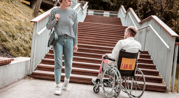 man in wheelchair unable to use stairs